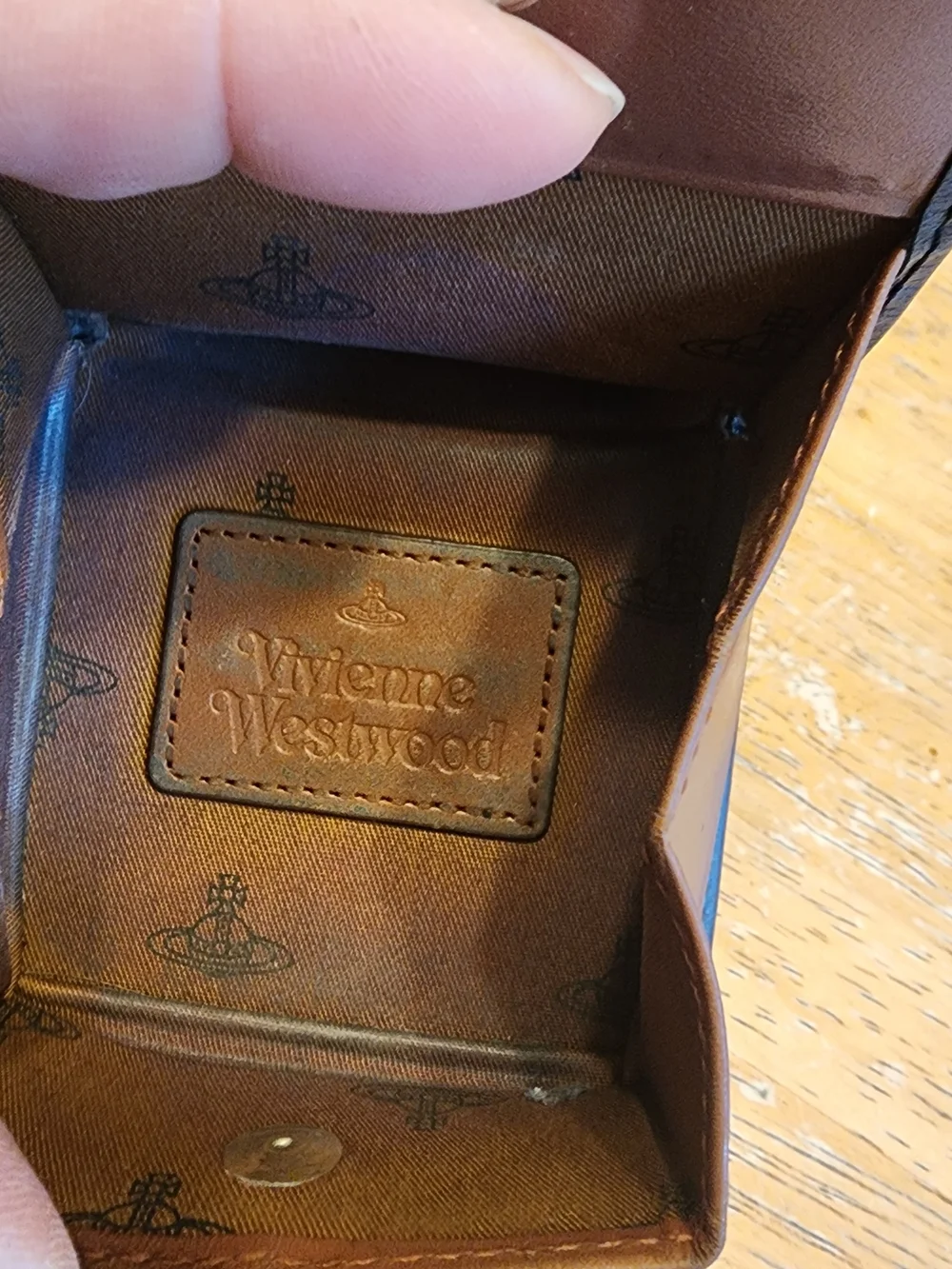 leather Vivienne Westwood coin case features an embossed logo patch on the
